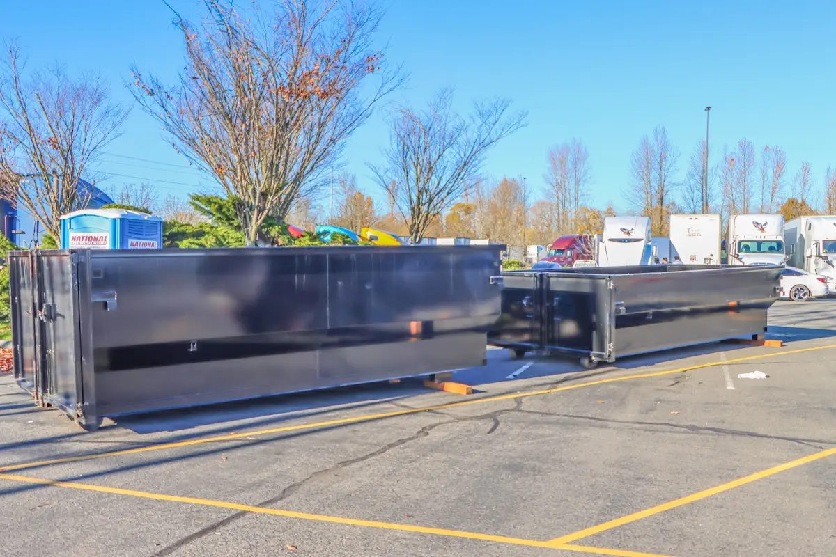 Professional dumpster rental service with roll-off container on residential driveway in Whitehouse